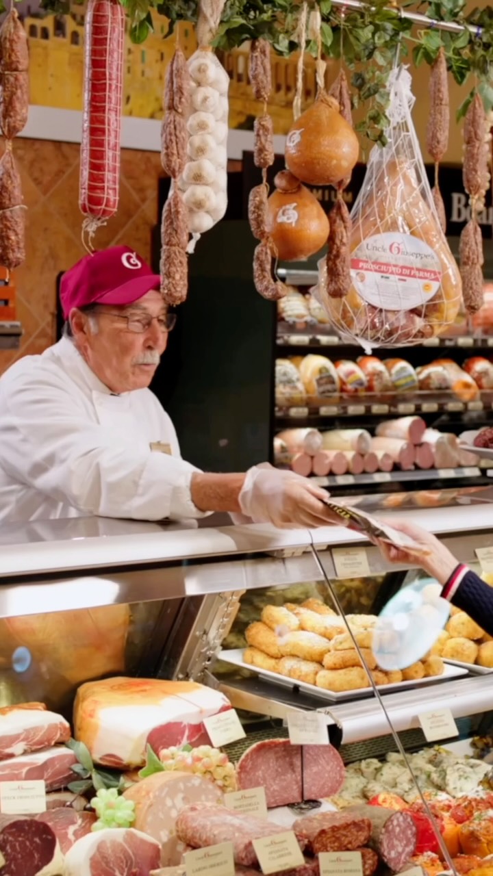 An Uncle Giuseppe's deli artisan serving a customer